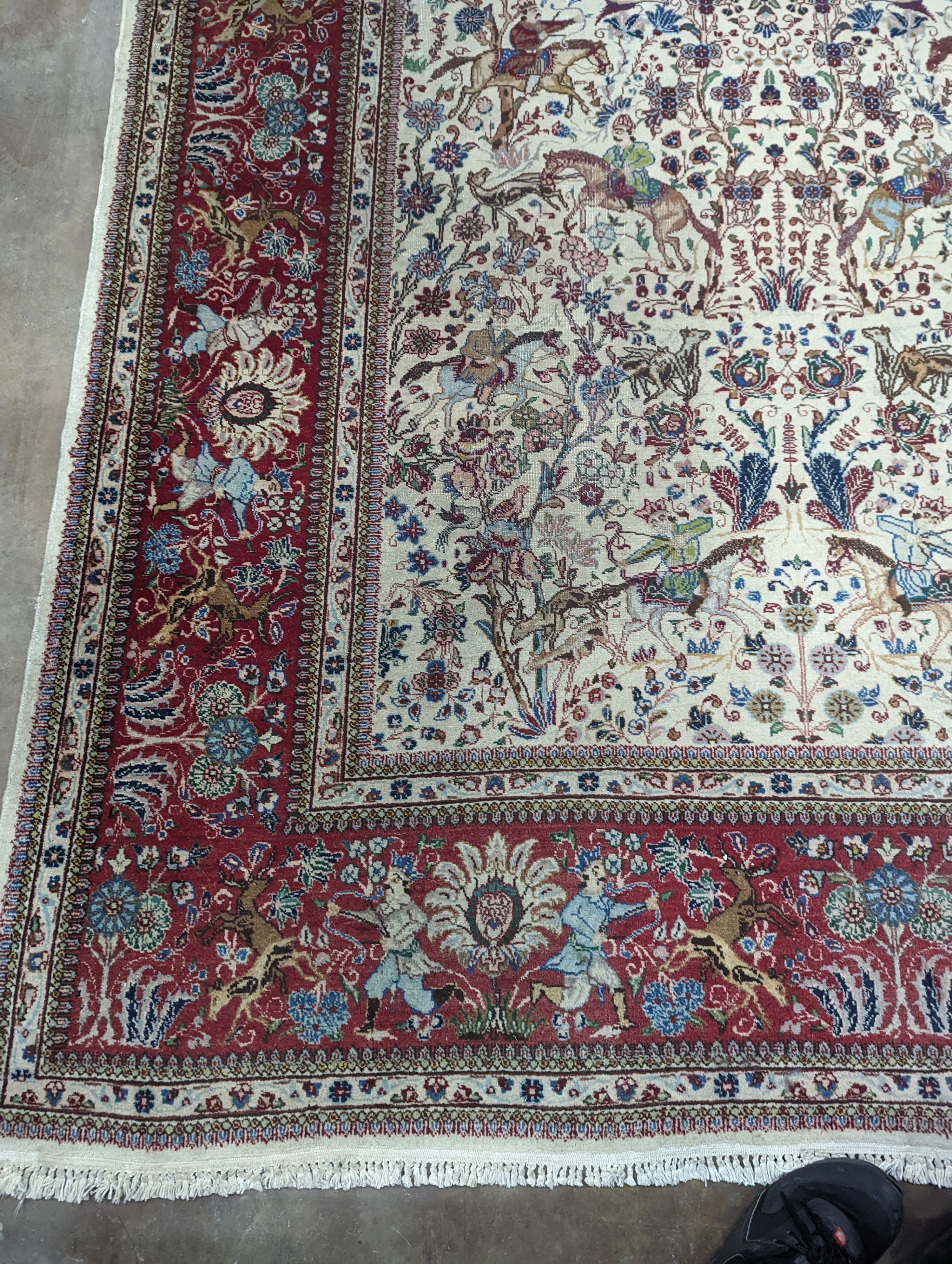 A Tabriz ivory ground pictorial rug (signed), 390 x 294cm